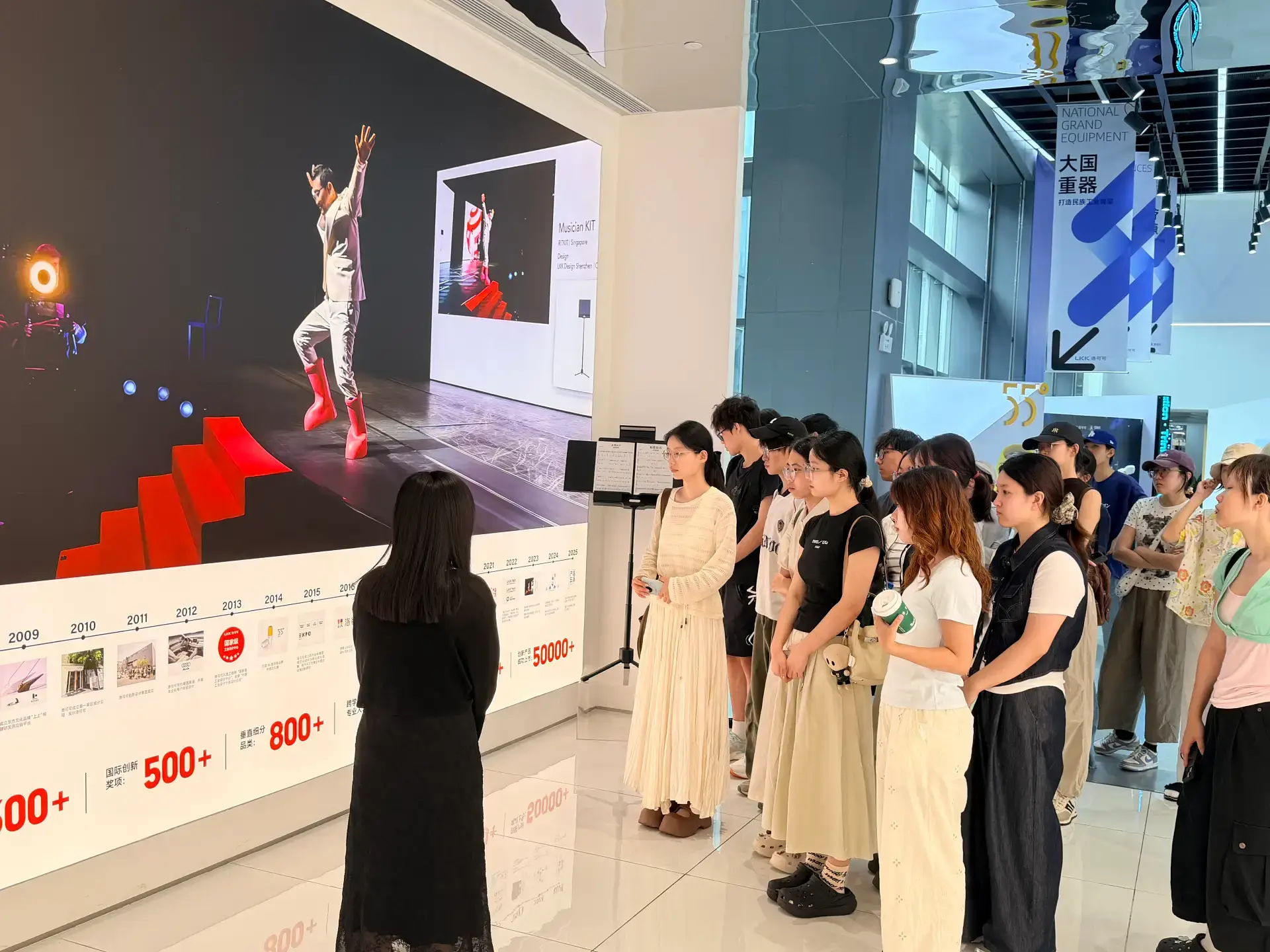 HIT students touring the LKK Design showroom, viewing 600+ international awards and 50,000+ design cases