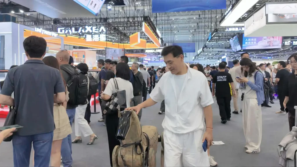 Jia Wei LKK Design founder interacting with DeepRobotics humanoid robot air hockey WRC 2026 industrial design