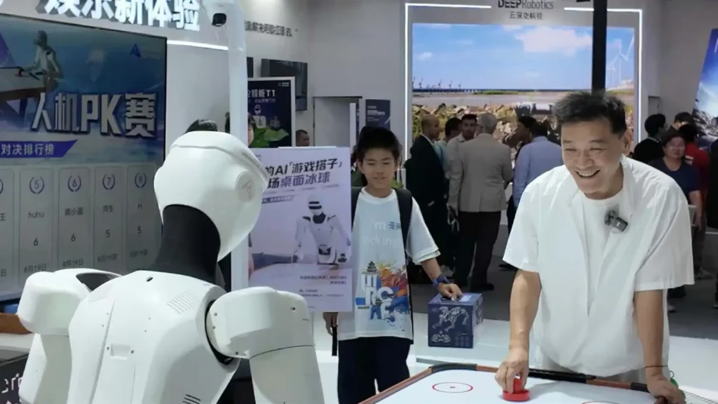 Jia Wei LKK Design founder interacting with DeepRobotics humanoid robot air hockey WRC 2026 industrial design